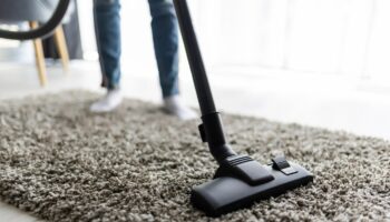 people-housework-housekeeping-concept-close-up-woman-with-legs-vacuum-cleaner-cleaning-carpet-home_231208-13612-1