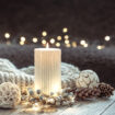 Cozy Christmas composition with a candle on a blurred background.