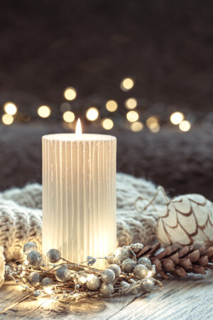 Cozy Christmas composition with a candle on a blurred background.