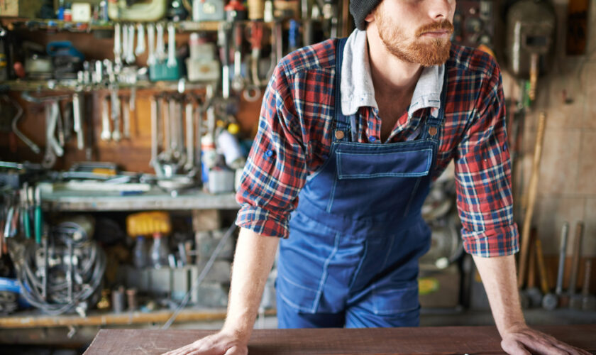 Portrait,Of,Unrecognizable,Bearded,Male,Leaning,On,Table,With,Wrenches